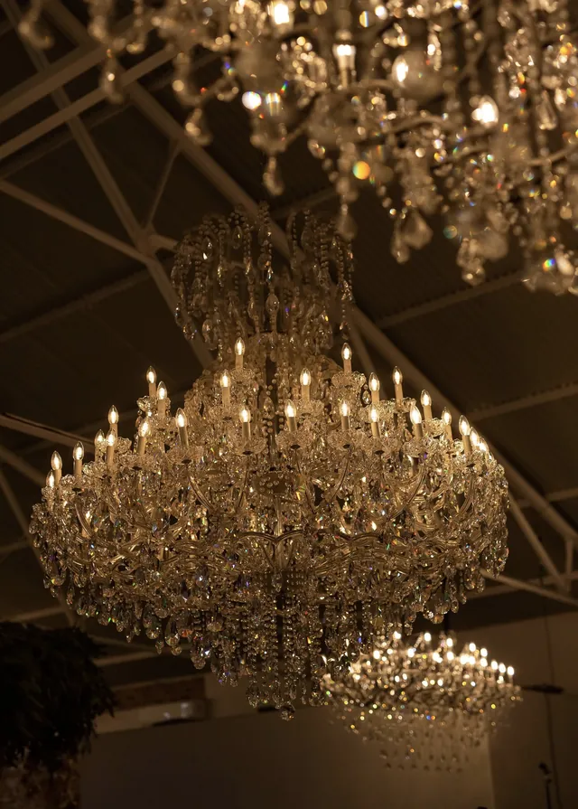 Crystal chandeliers hanging above a venue ceiling