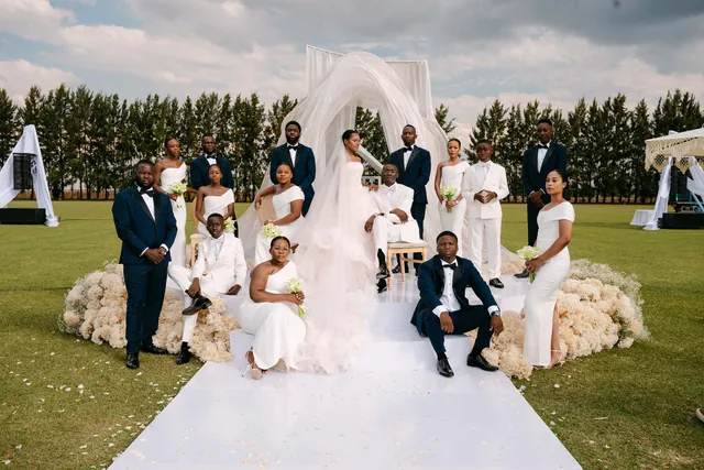 Wedding party in front of a white ceremony installation
