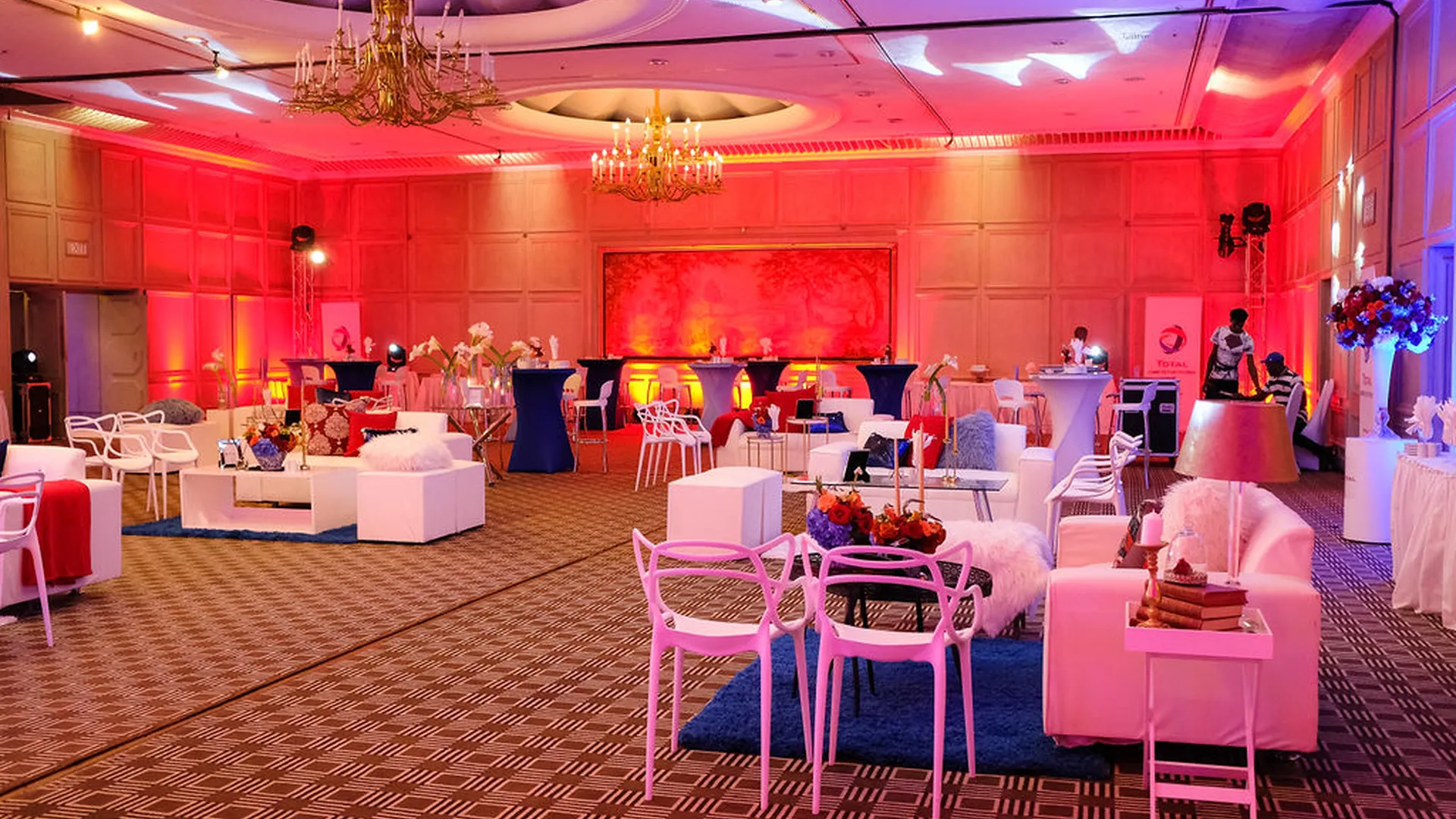 Contemporary corporate lounge styled with vivid red and violet lighting