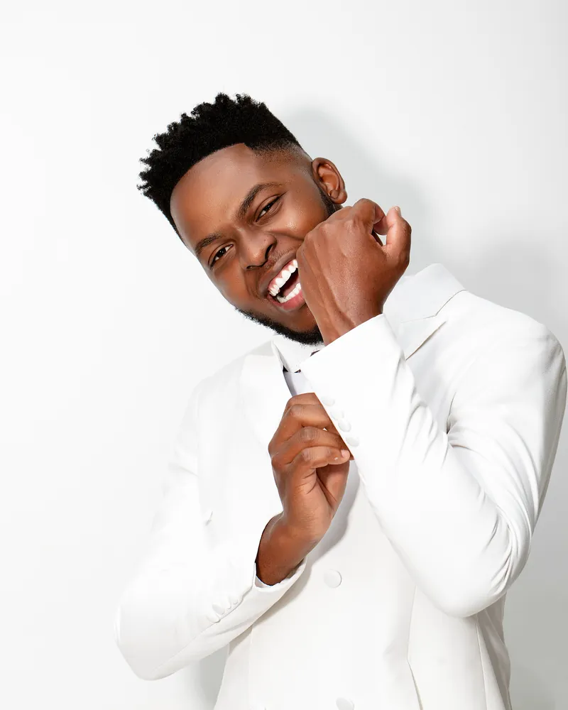 Kevin in a white suit