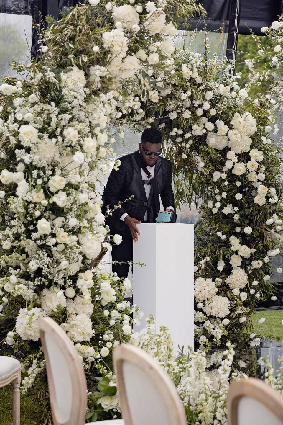 Kevin working among white floral installations at an event