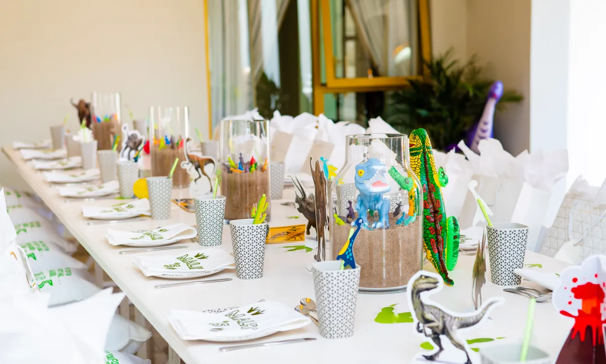 Children's dinosaur birthday table with colourful place settings