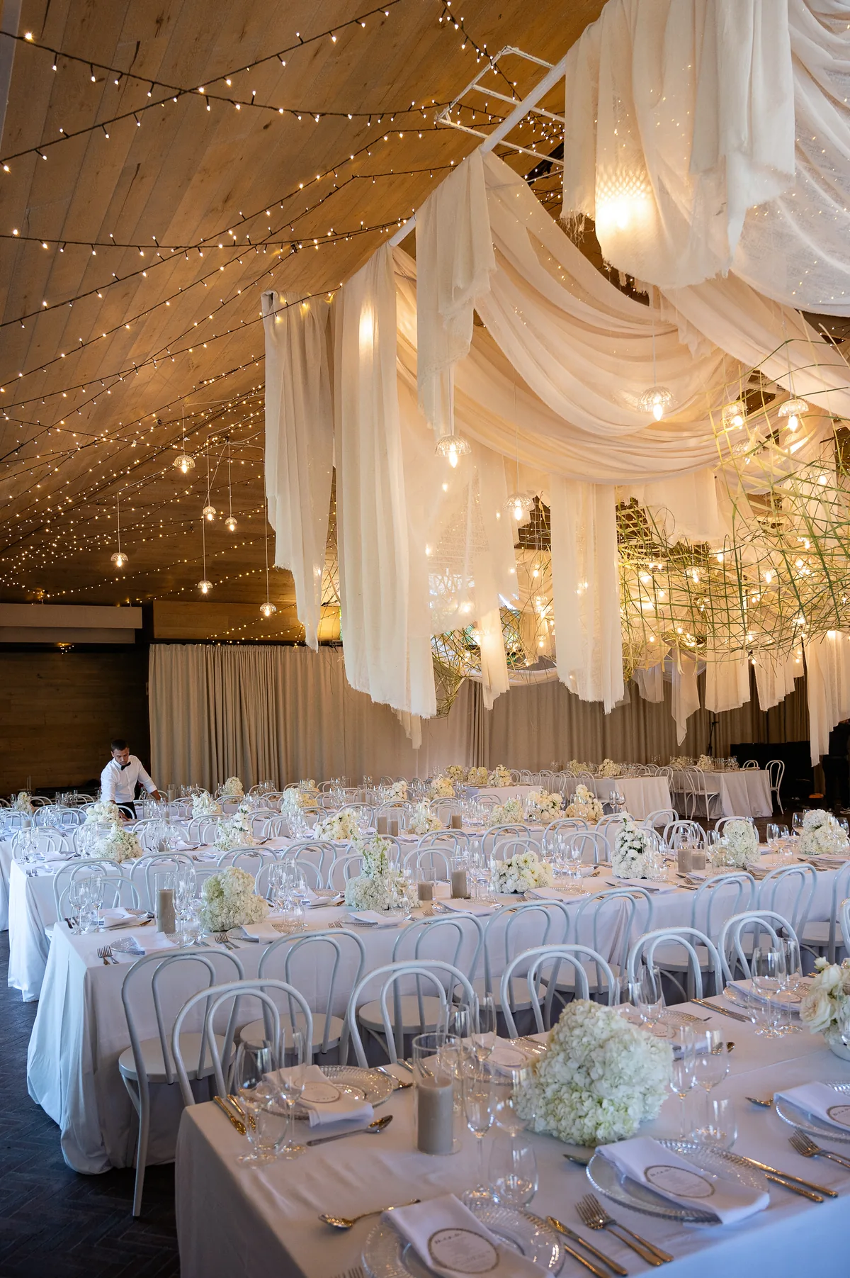 Draped reception room glowing with candlelight