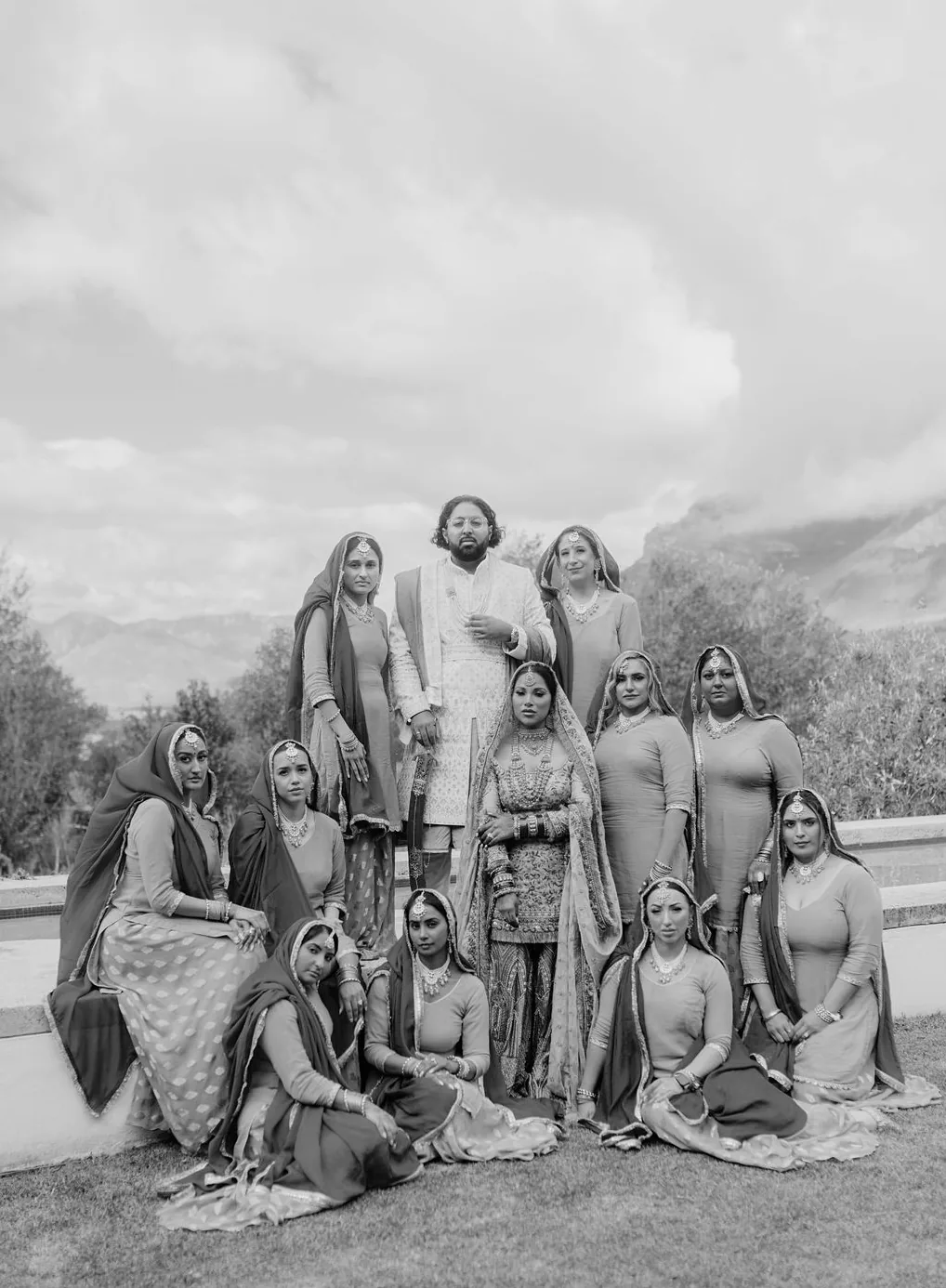 Black-and-white wedding-party portrait against the Cape Town mountains