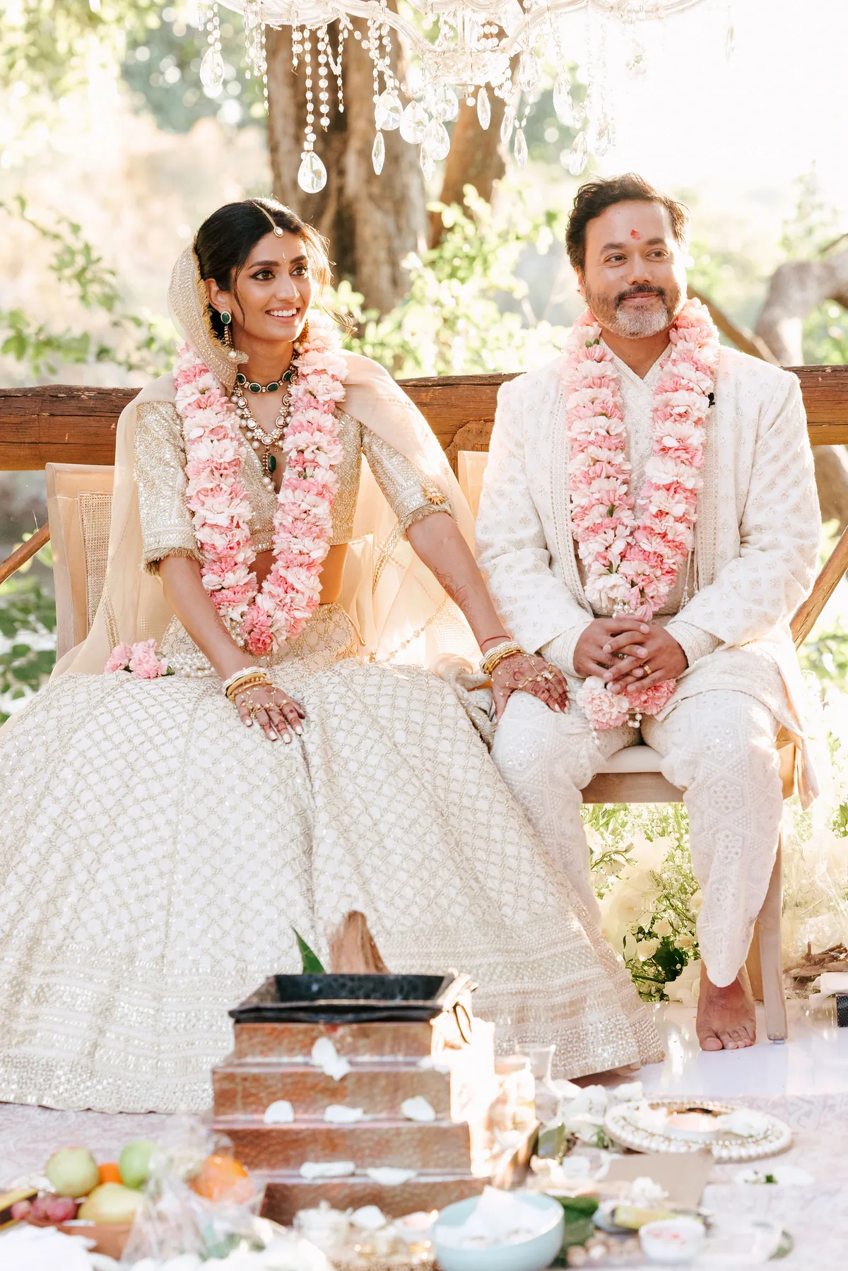 The couple seated during a traditional ceremony