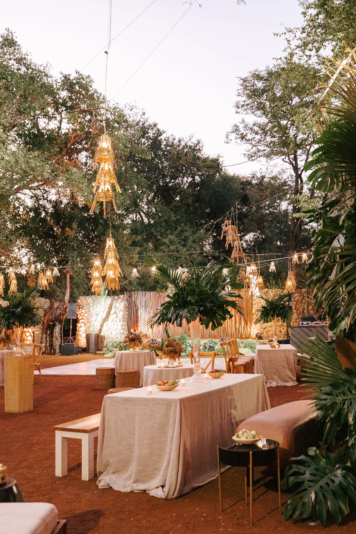 Outdoor lounge framed by trees and lanterns