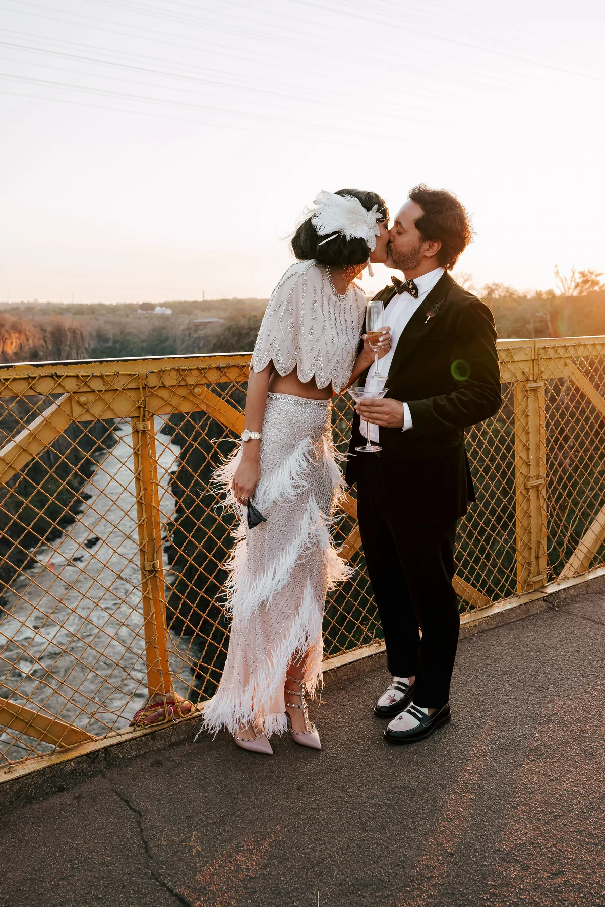 Couple embracing beside the railway at sunset