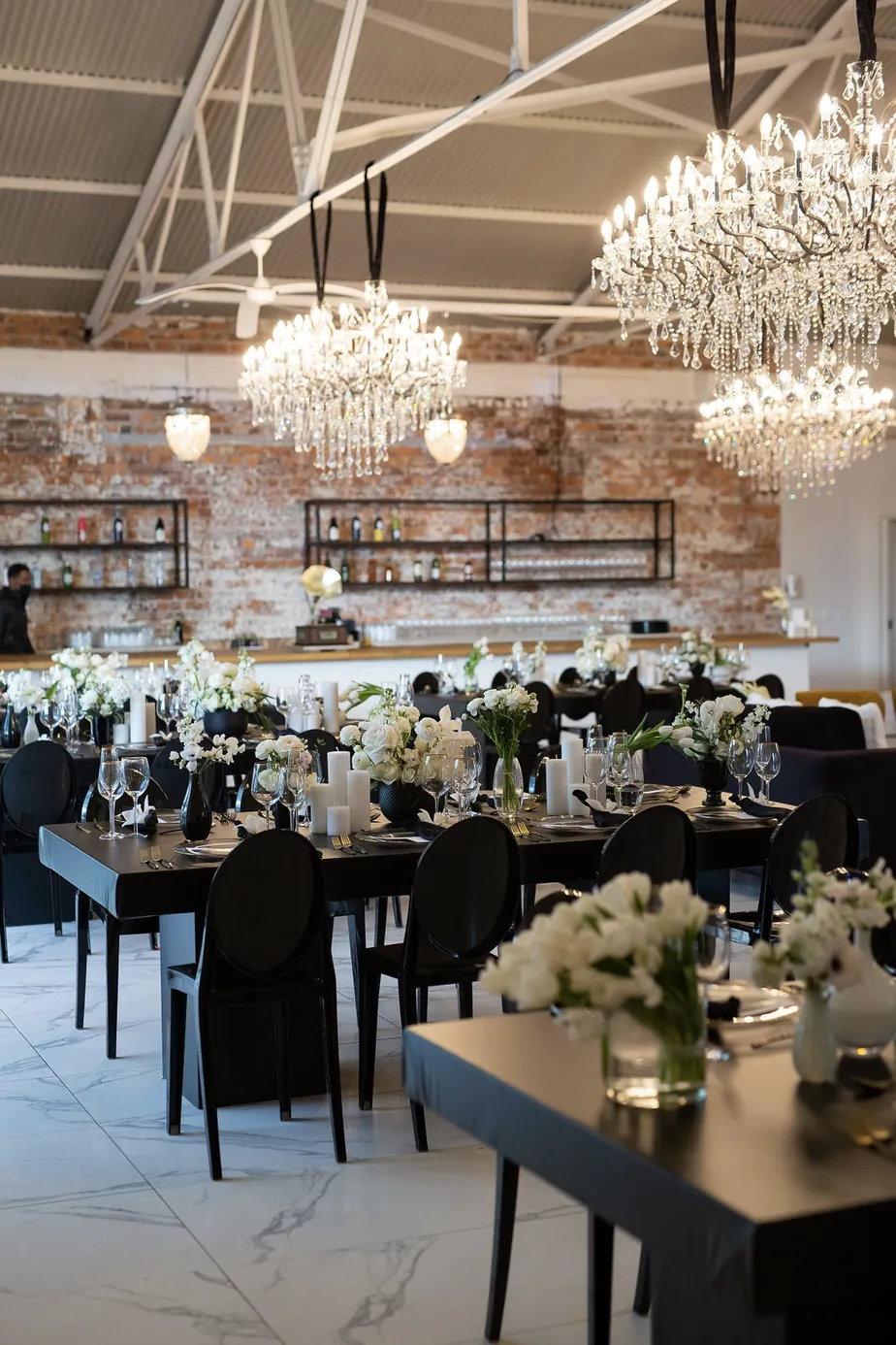 Crystal chandeliers above the candlelit dining room