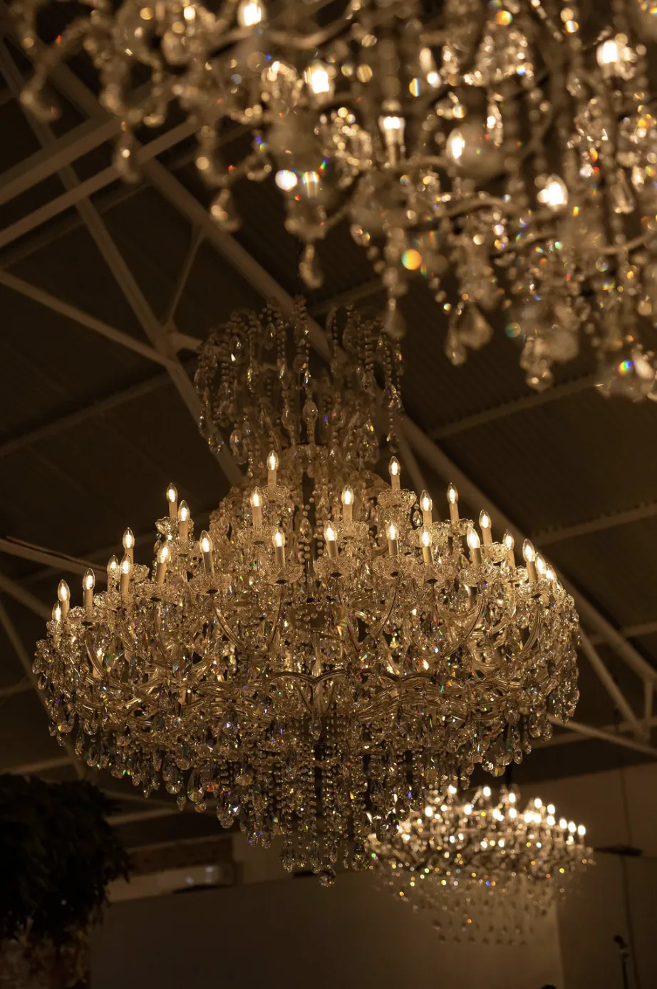 Tiered crystal chandeliers glowing above the reception